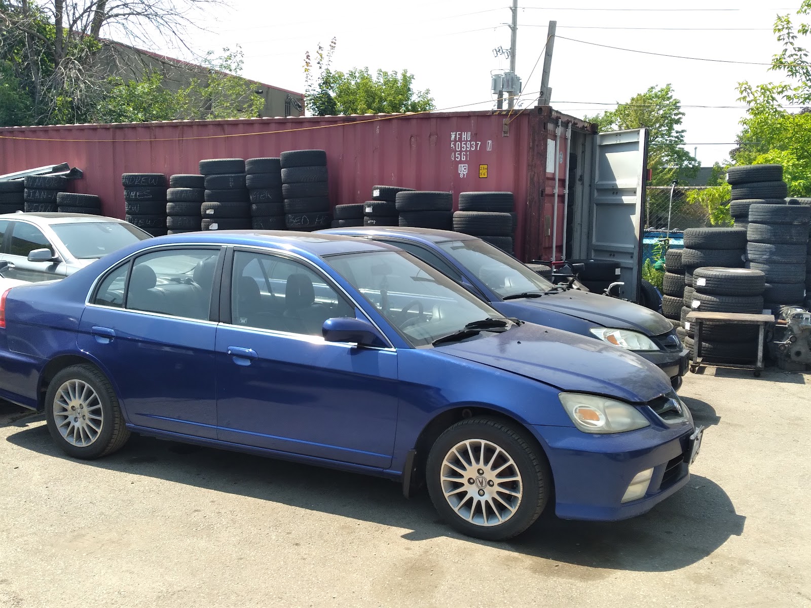 A car parked outside the shop, awaiting service